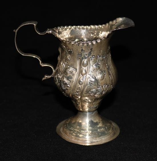 A George III silver cream jug with later decoration, 4in.